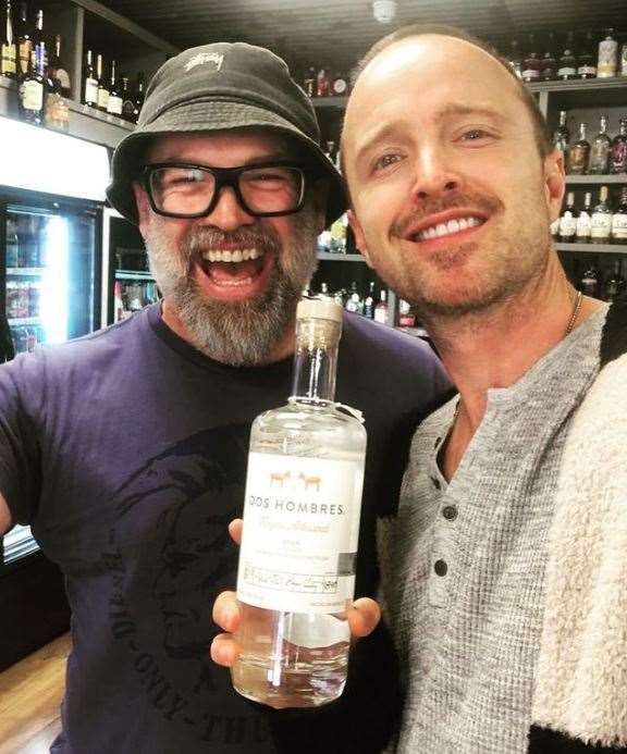 Aaron Paul poses with The Offy manager Ross Bell and a bottle of his mezcal, Dos Hombres. Pic: Ross Bell