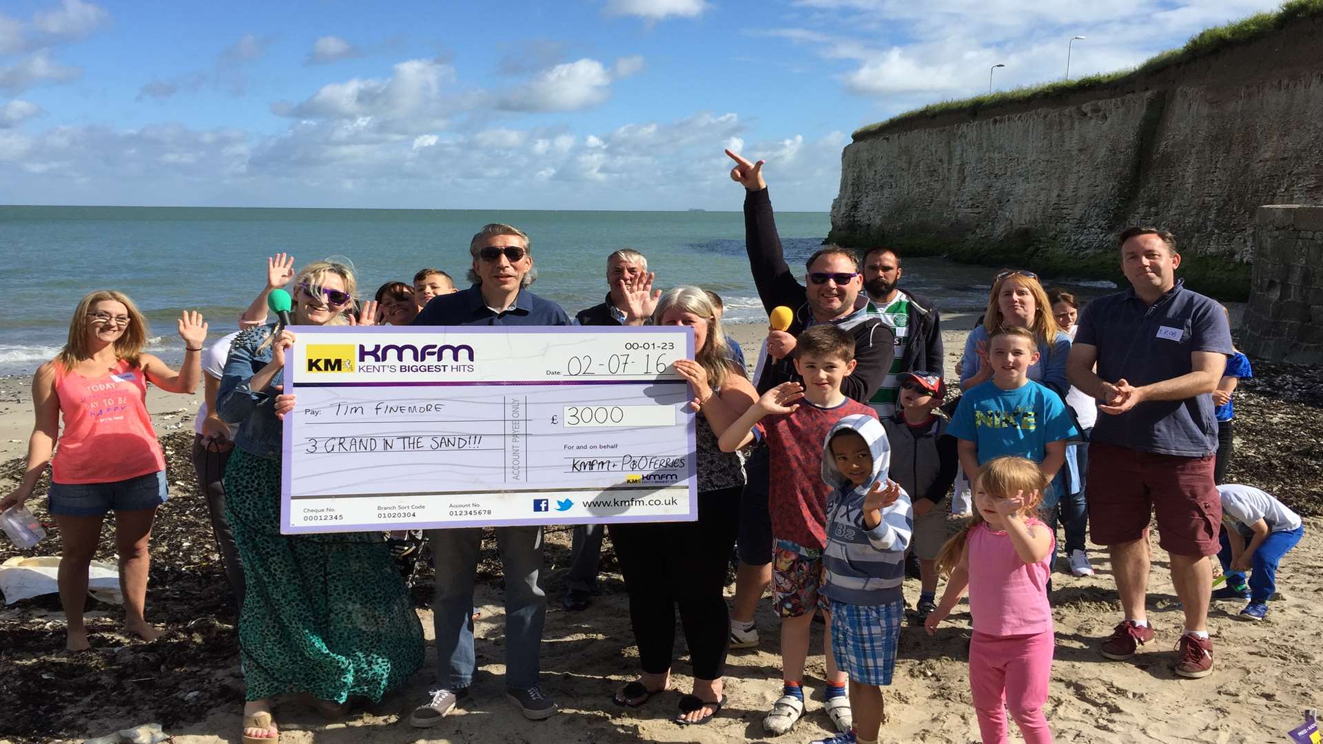 Tim Finemore from Dover with his £3,000 prize cheque, courtesy of kmfm's 3 Grand in the Sand contest
