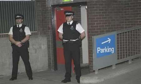 Police officers standing guard on the fourth floor of the car park