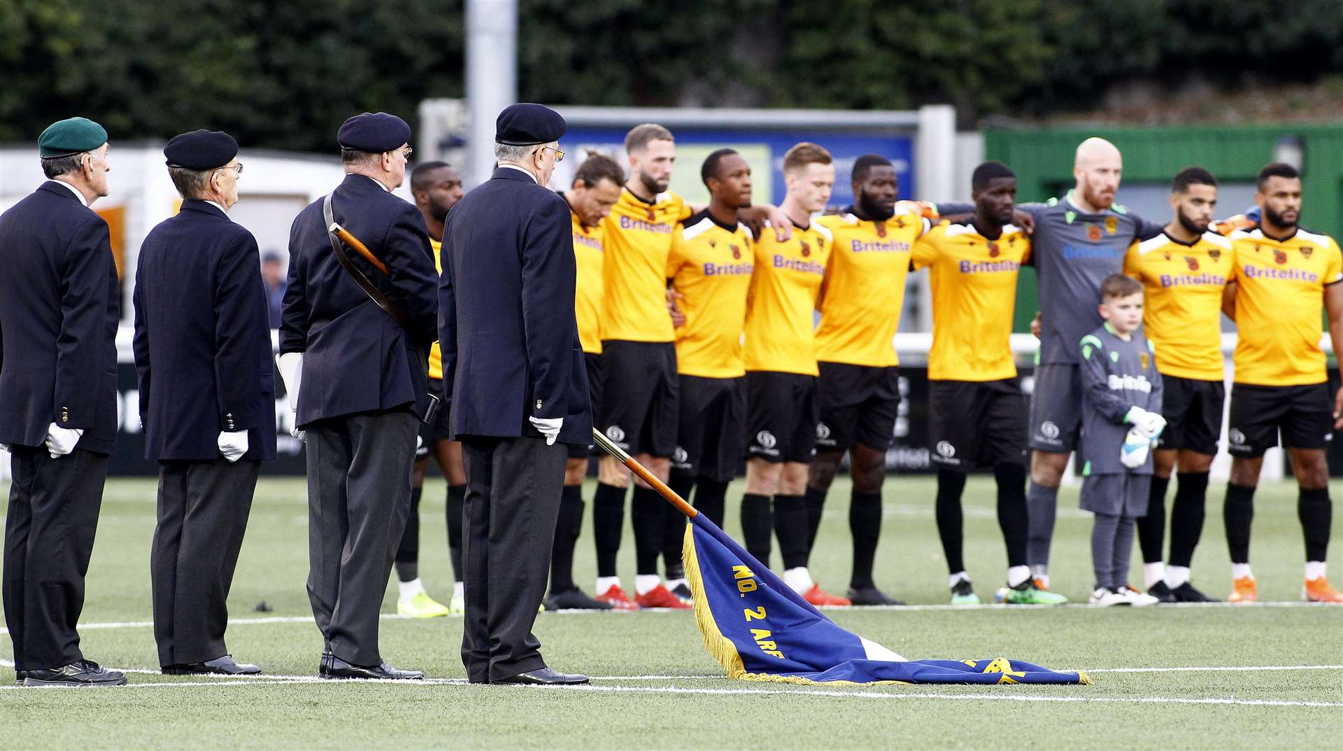 Maidstone players show their respect ahead of the FA Cup match with Torquay. Picture: Sean Aidan FM21261769