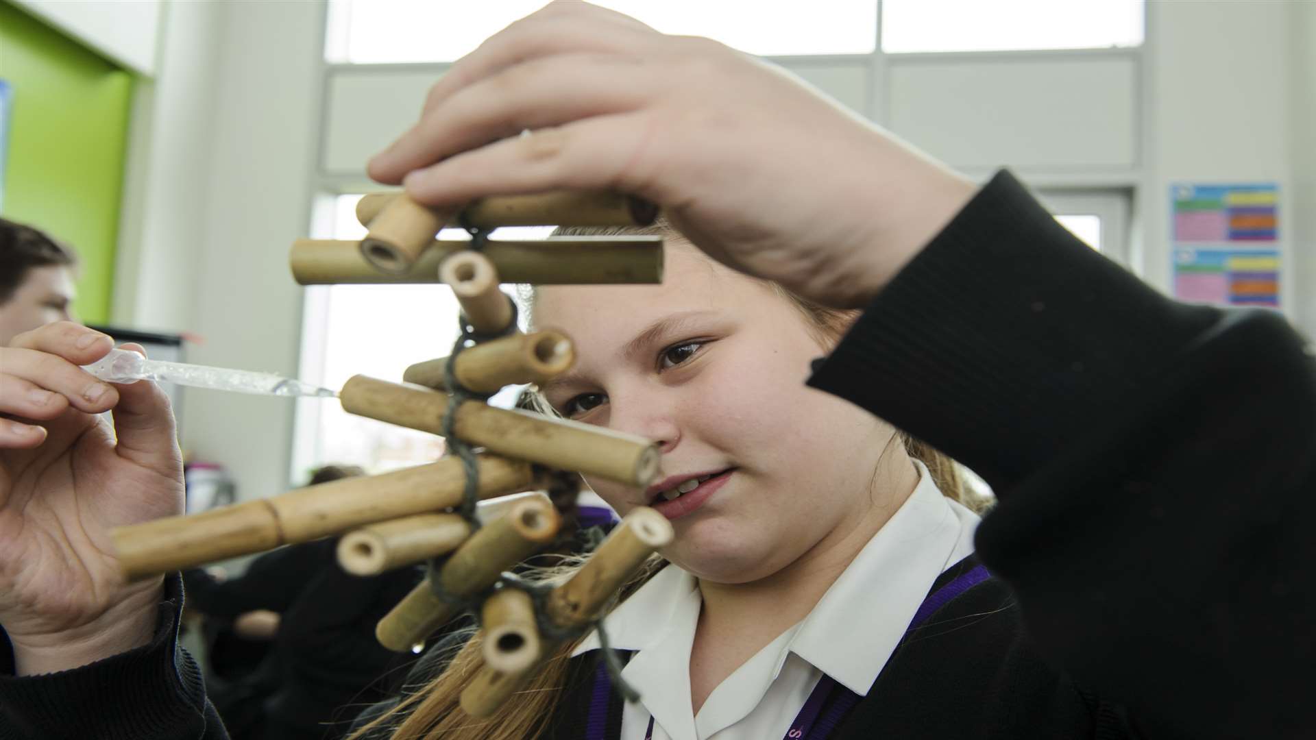 Billie Jane Burton, 12, adding sugar solution to her Bee Hotel