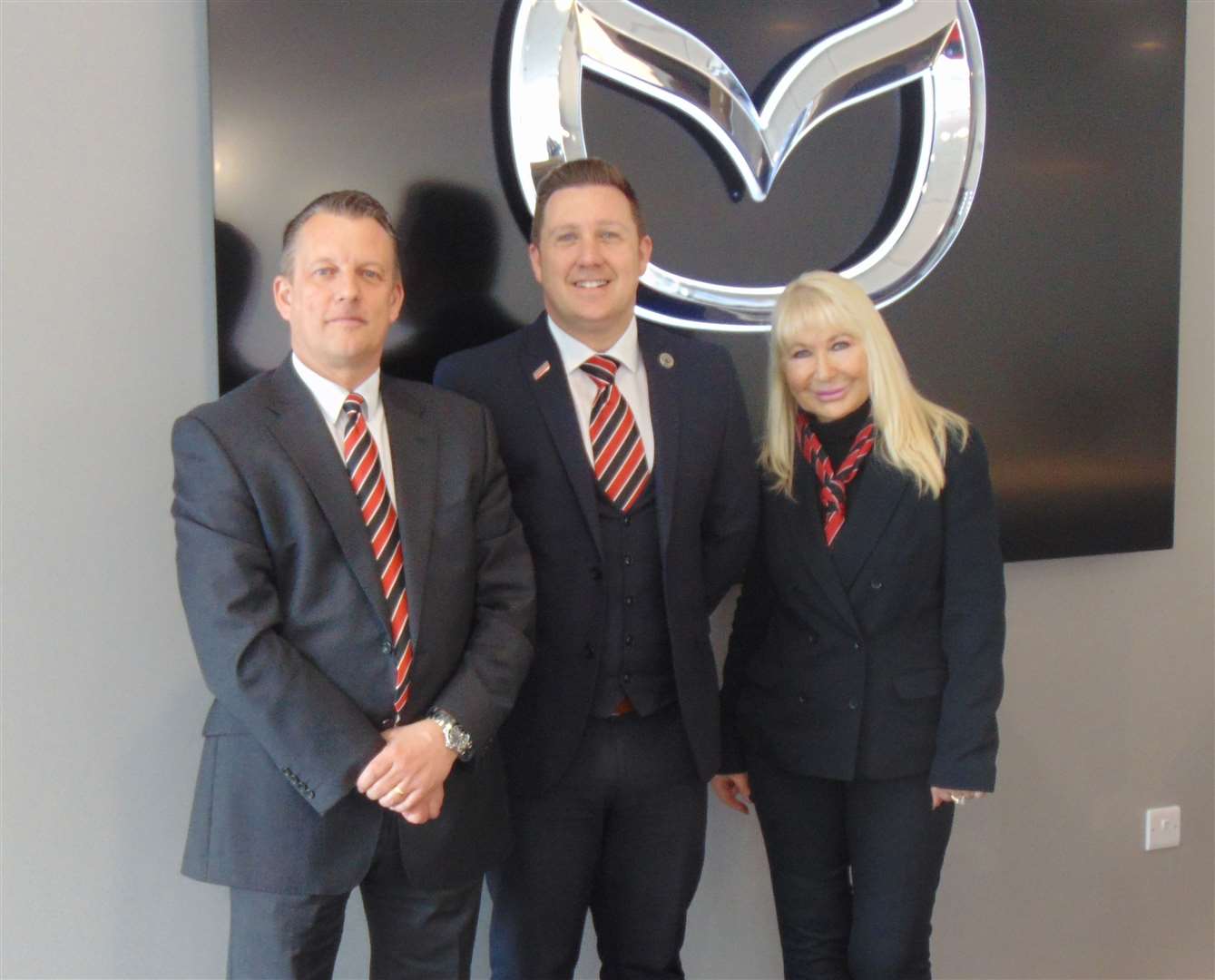 Denise Millard, executive director at Perrys, joined by Darren Ardron, Perrys MD, left, and Michael Latham, general manager, Perrys Mazda Canterbury (10962683)