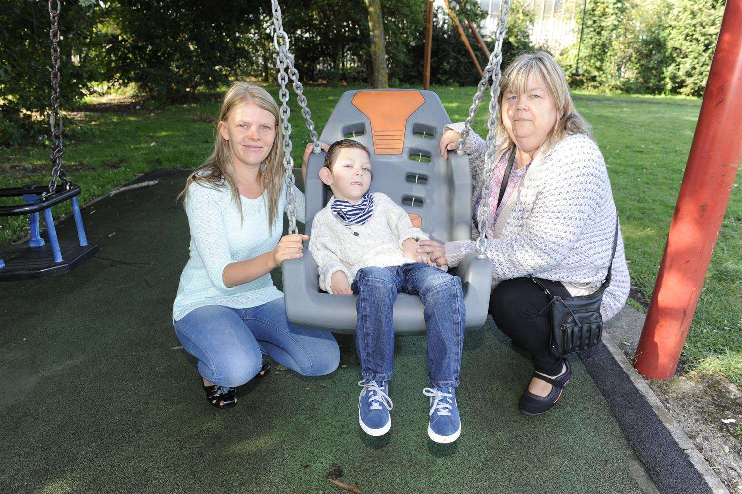 Six-year-old Sean Munday with mum Naomi (right) and Linda Munday, pictured when the swing was installed