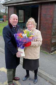High Halden Parish council chairman Alan Pickering imaking a presentation to Pat Hukins who is retireing after being the village cleaner who looks after the bus shelters in all weathers.