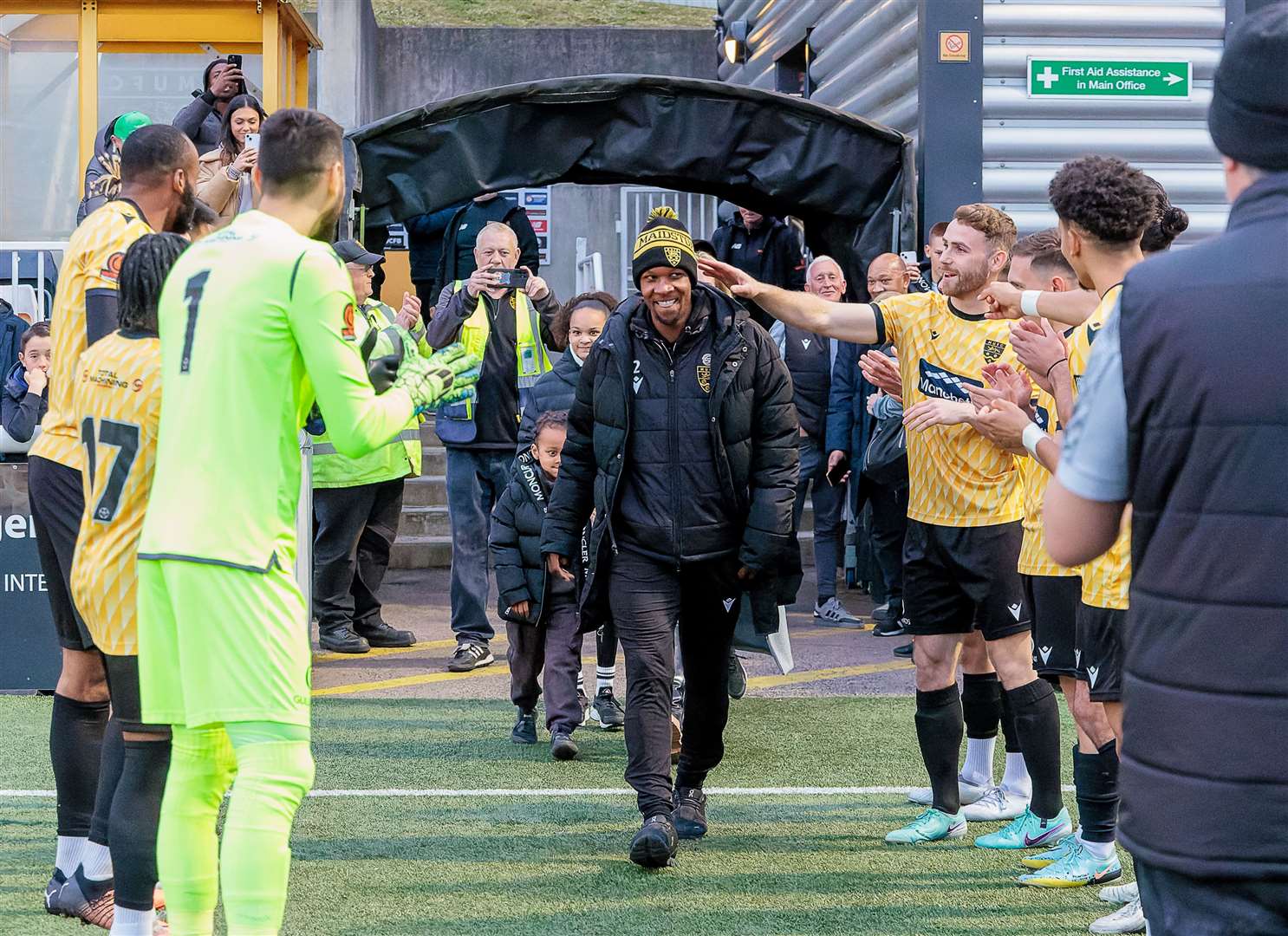 Maidstone players form a guard of honour for departing captain Gavin Hoyte. Unbeknown to the defender, his family are right behind him. Picture: Helen Cooper