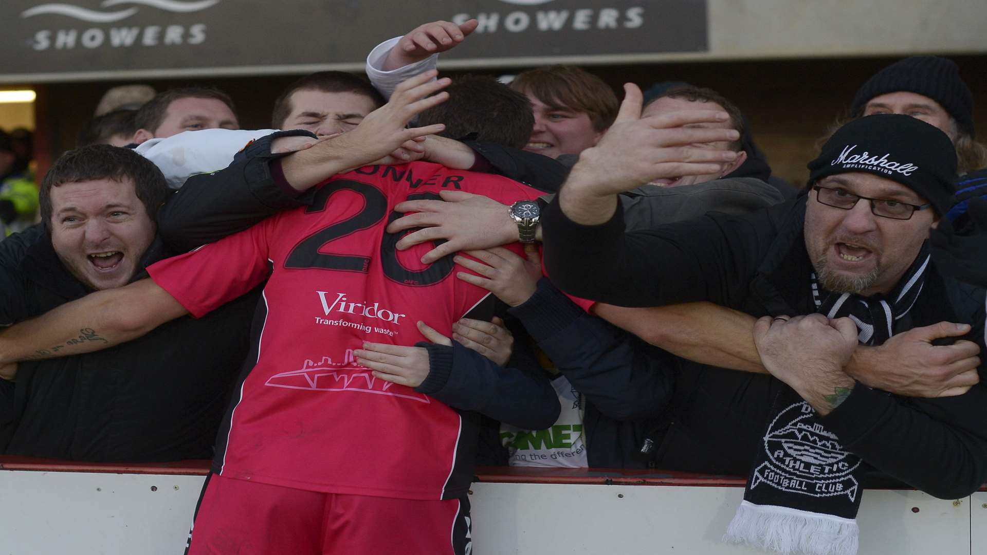 Tom Bonner celebrates the second round win at Cheltenham with Dover fans. Picture: Ady Kerry