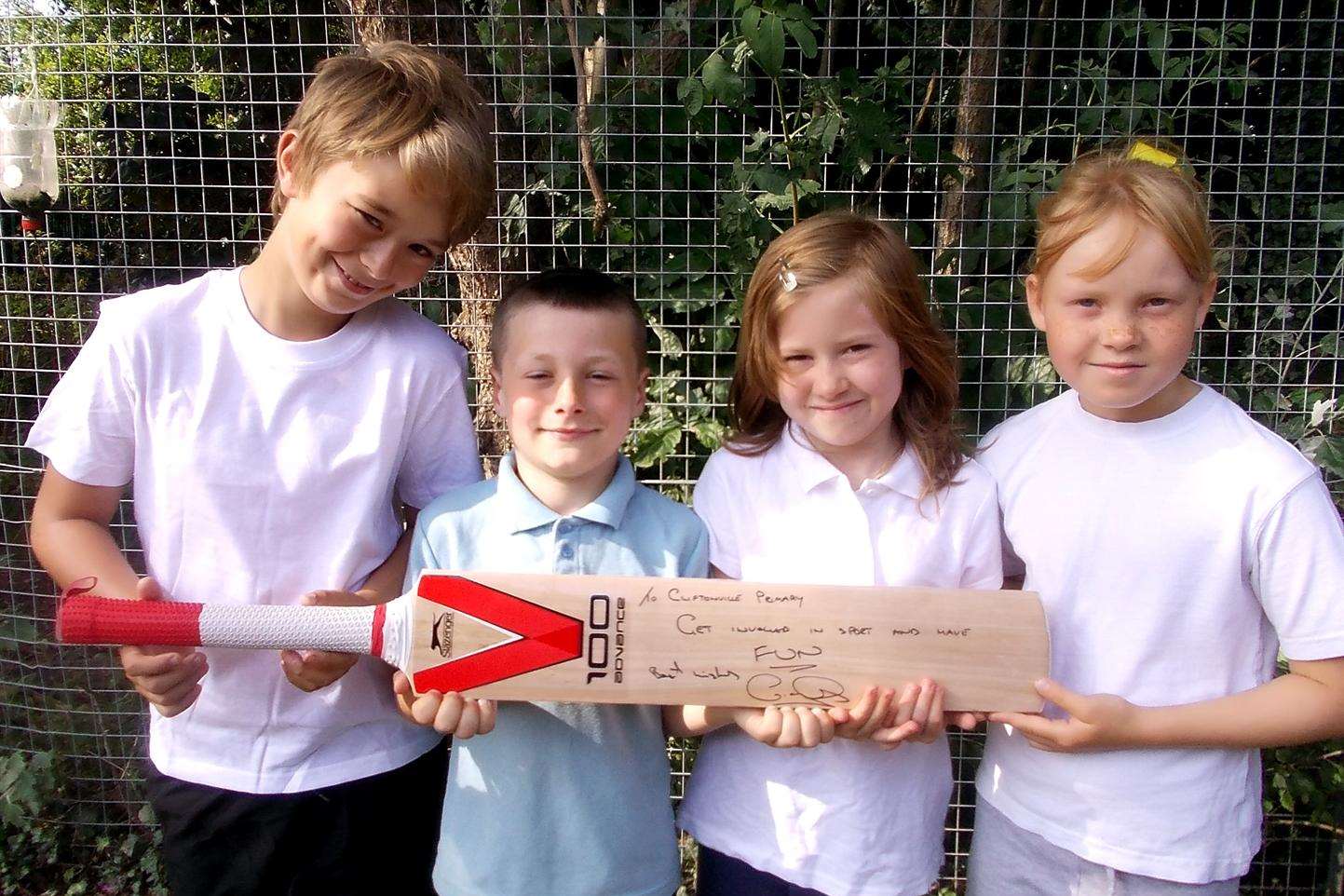 Proud youngsters show off the signed cricket bat donated to Cliftonville Primary School by their VIP visitor and top sports star Geraint Jones.