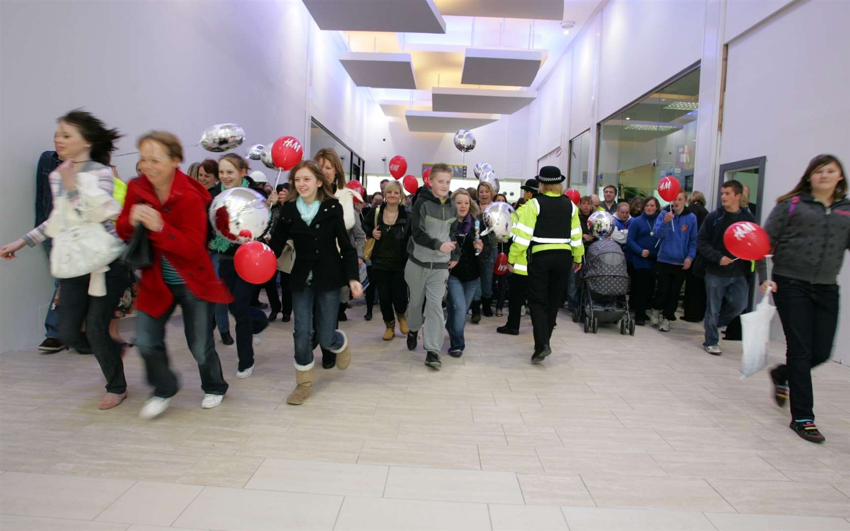 Shoppers rush into the centre's extension on its opening day in March 2008