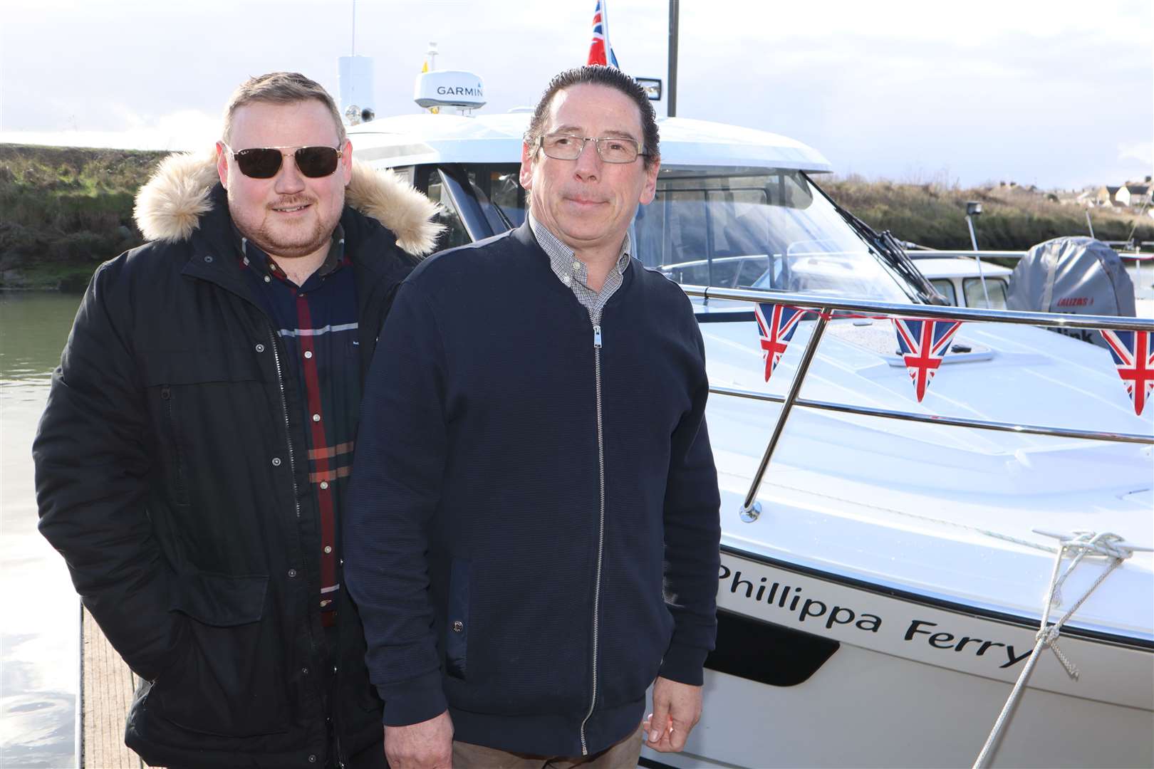 Adam Ervin, owner of the Queen Phillippa guest house at Queenborough with his son Jake and the £185k Merry Phillippa ferry which will be linking Sheppey to Southend