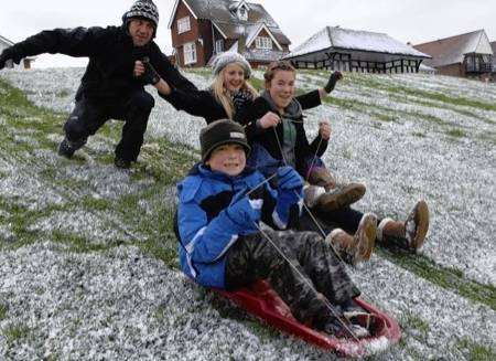 Micheal Alton gives a push to Herbie Alton, Ann-Marie Lucas and Felicity Alton on their sledges at Tankerton Slopes on Sunday afternoon. Picture:Chris Davey
