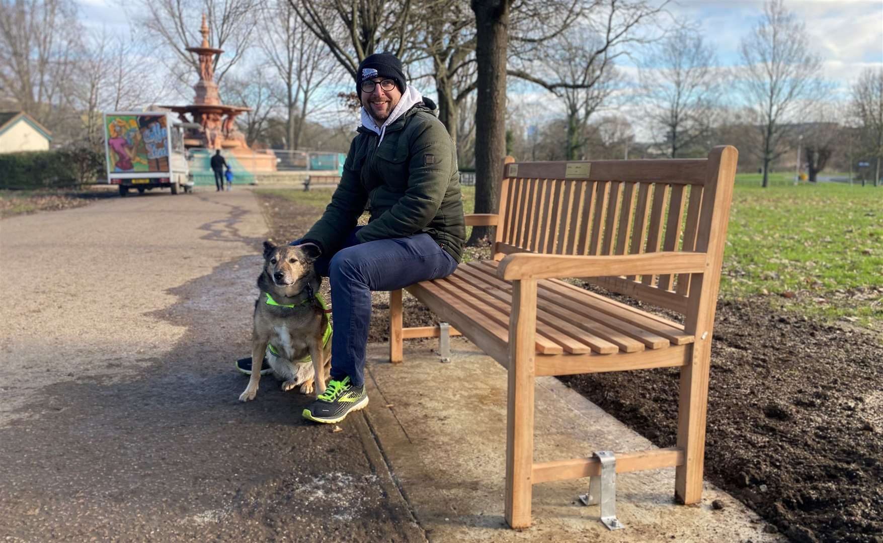 Roger Batho, Victoria Park project team leader, enjoying the new bench with his pooch last month. Picture: Ashford Borough Council