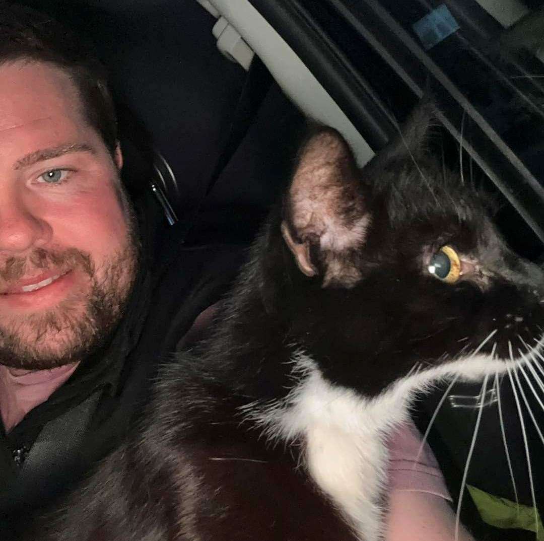 Billy Devitt with Ronald, one of the cats he saved last week. Picture: Wisteria Cat Rescue