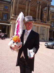 Derek McCarrick, with his Roger Rabbit costume and MBE at Buckingham Palace