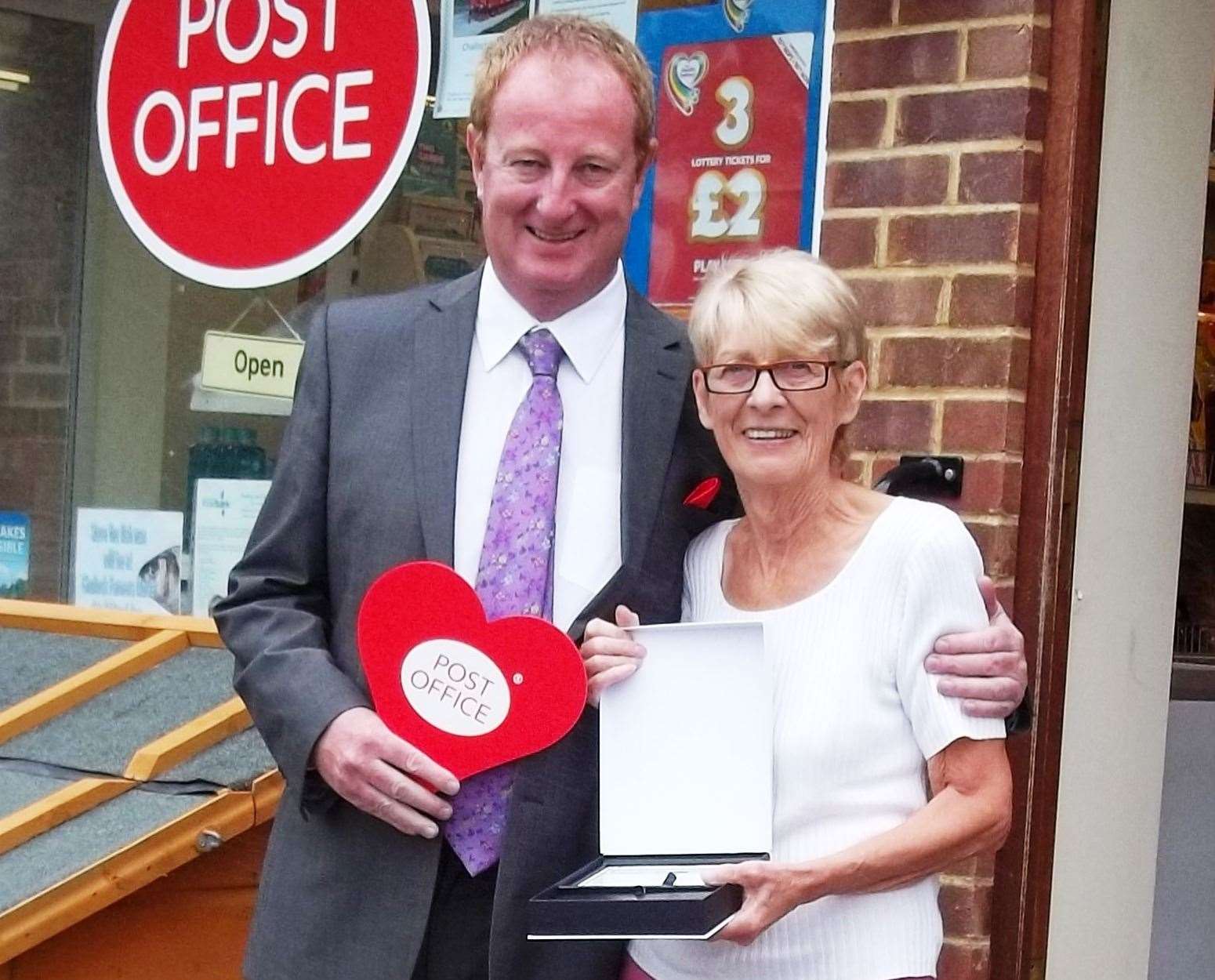 Angela Puxted receives her 30-year Post Office service award from Peter Wilkinson, Post Office area manager, in 2014