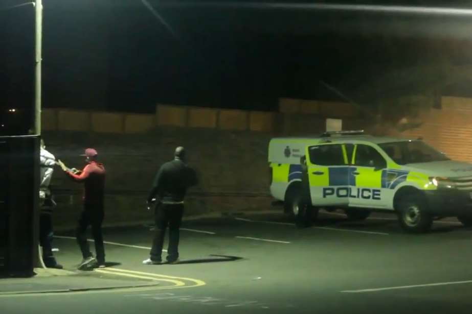 Police arrive as two men wrap tape around the 'victim’s' head, ankles and wrists