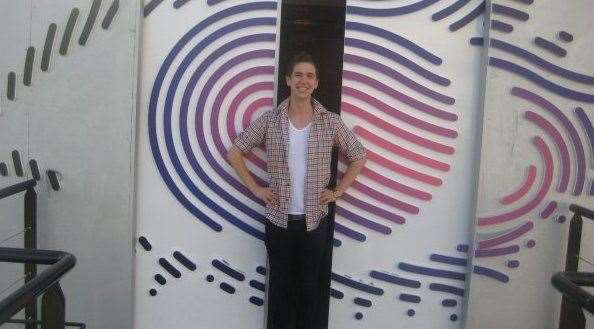 Nathan in front of the famous Big Brother house doors from his time on the show
