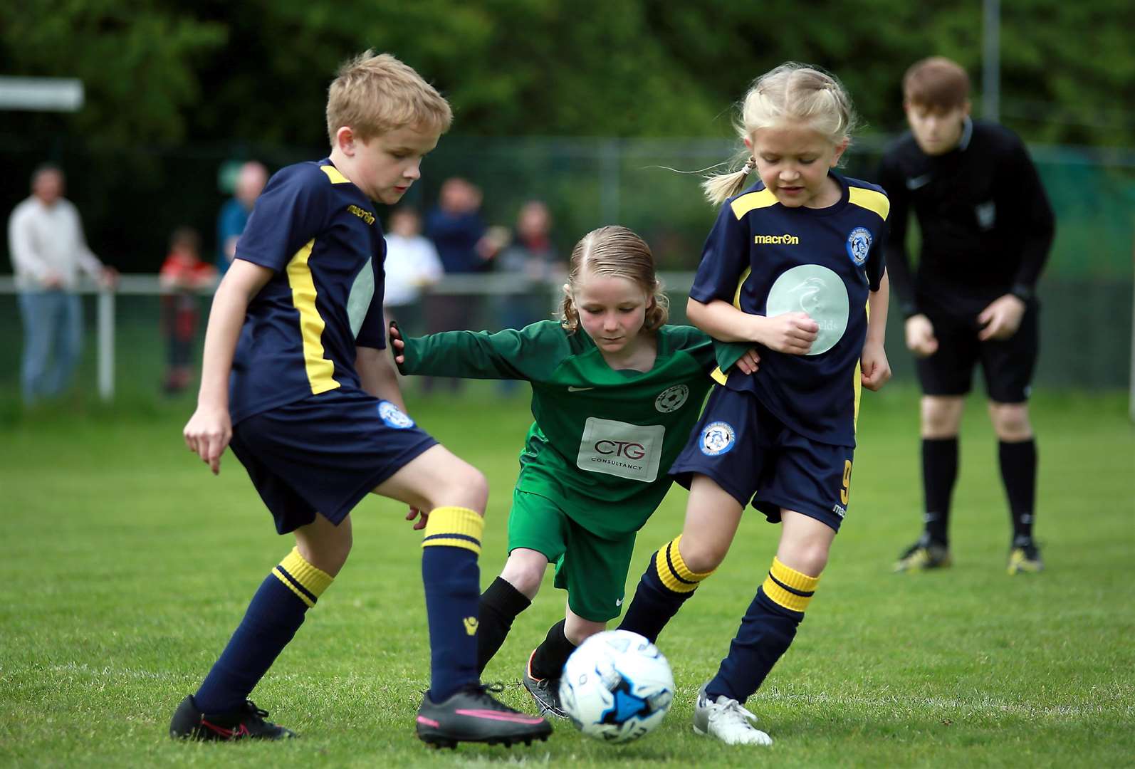 Under-8 Trophy final action between Iwade Heron Colts (blue/yellow) and New Ash Green Grasshoppers Picture: Phil Lee