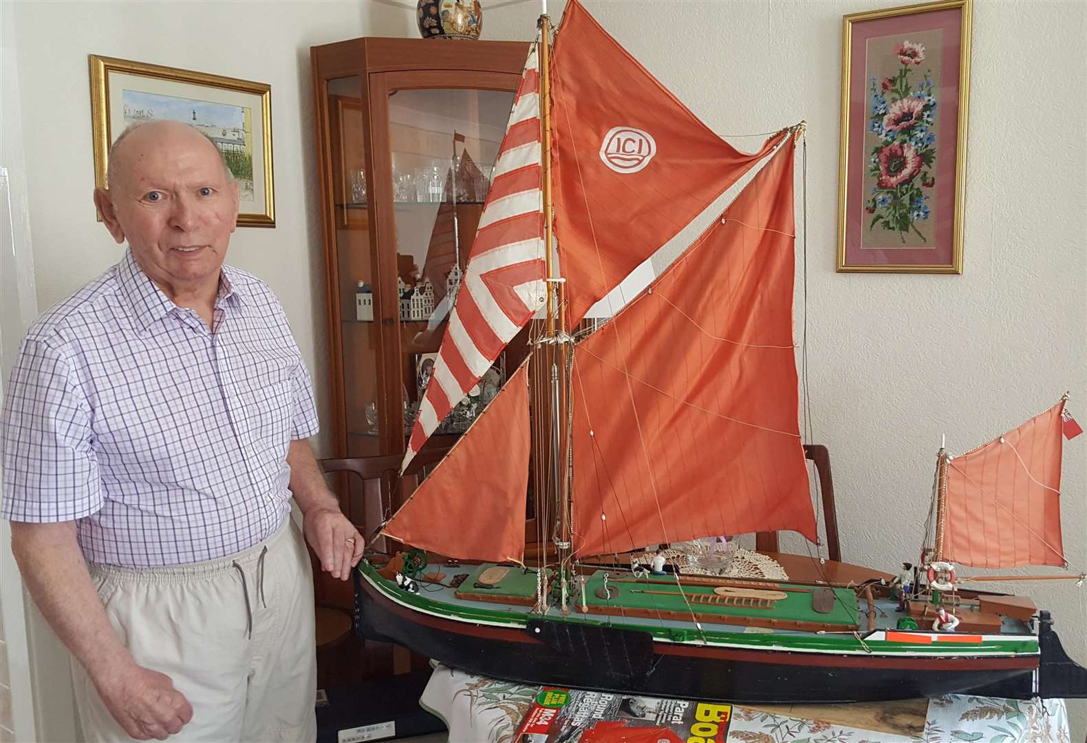 Bill Sutherland with his model of the barge Revival which he sails on local lakes