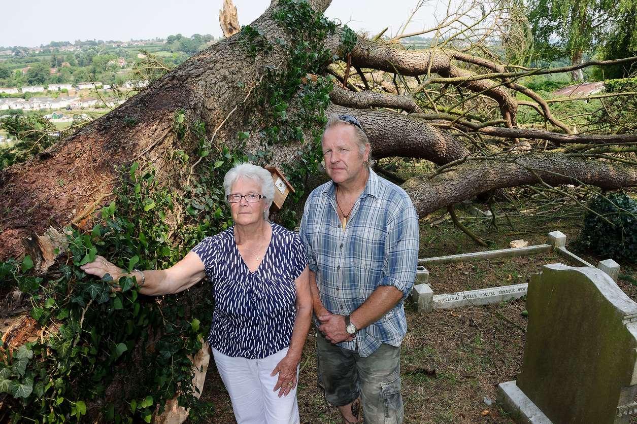 Gary Hindley and church keyholder Sheila Allchin with the fallen tree