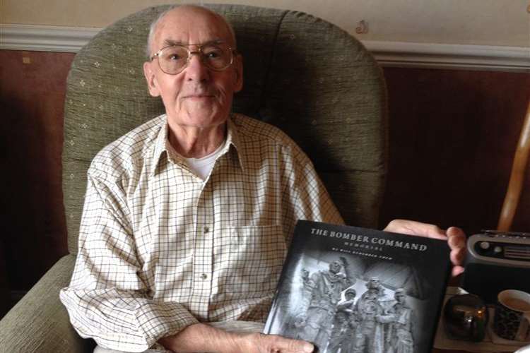 Former Lancaster Bomber Bill Webb with the book he was presented with