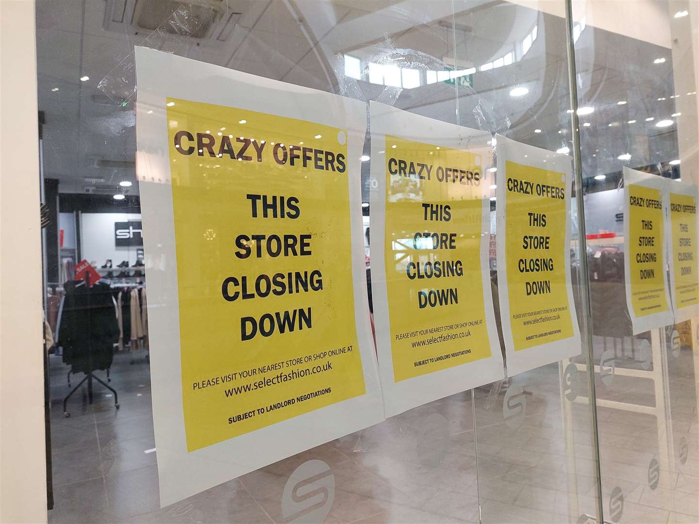 Signs displayed in the shop’s windows say “crazy offers, this store closing down”