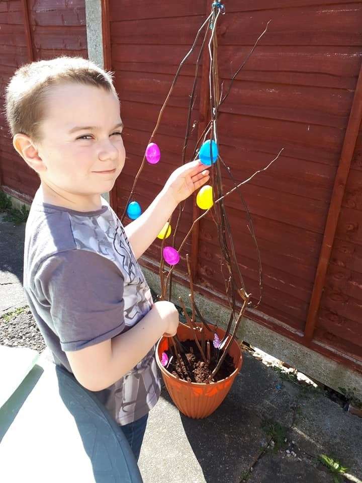 Eight-year-old Finley making the Easter tree