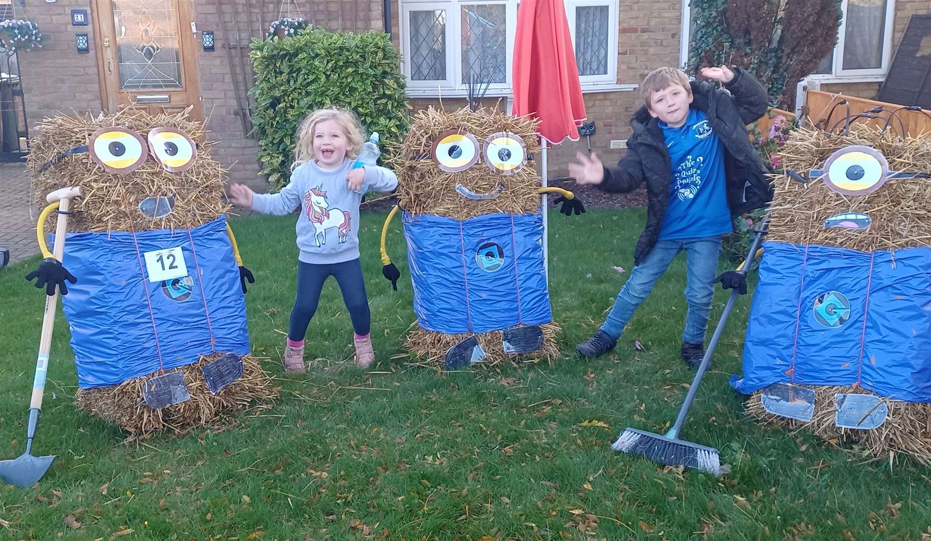 Children with last year's scarecrows in Lower Halstow village