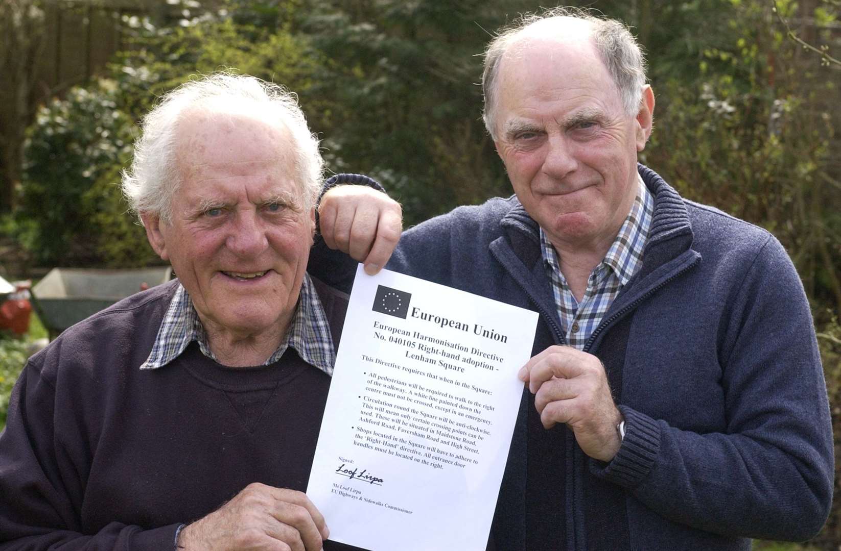John Philpott and Alan Huggett with the sign about new rules in Lenham, April Fool's Day 2005