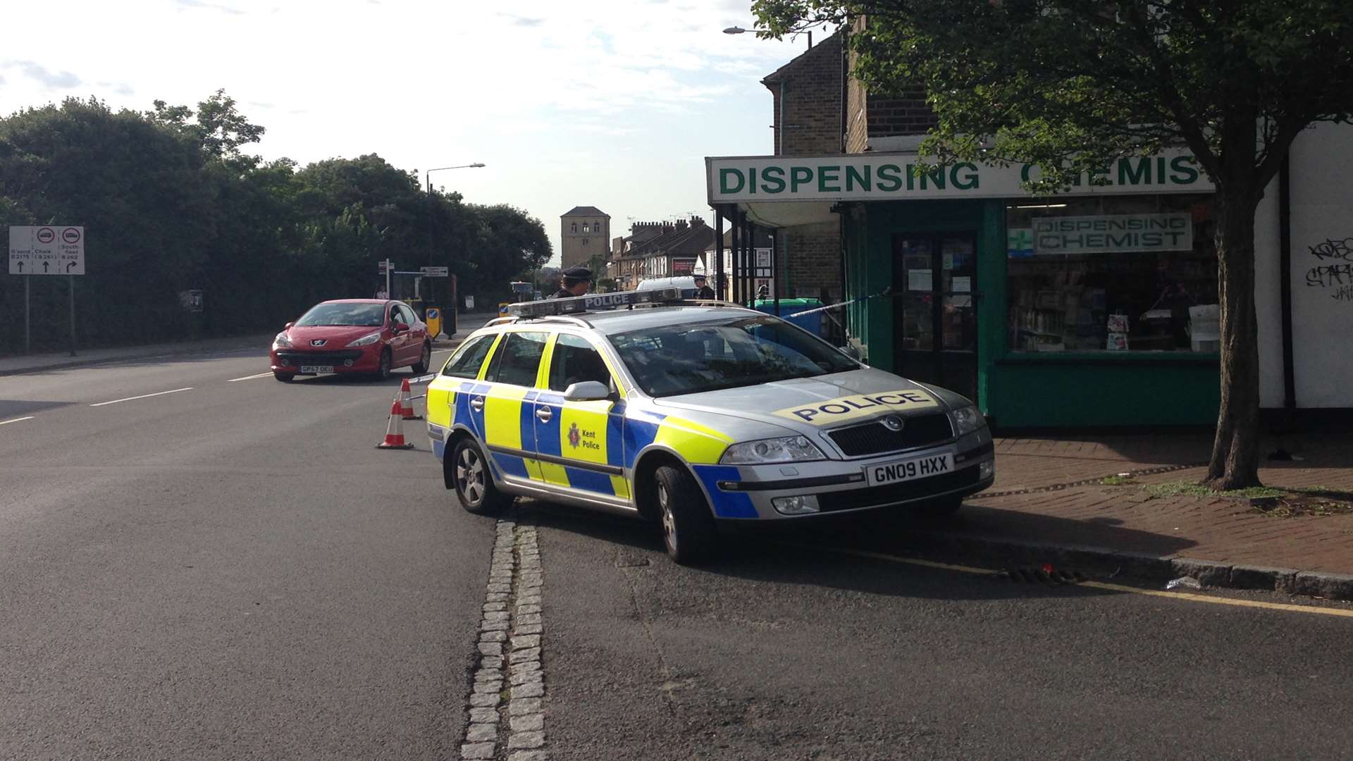 A police car is parked outside the chemist's following the attack
