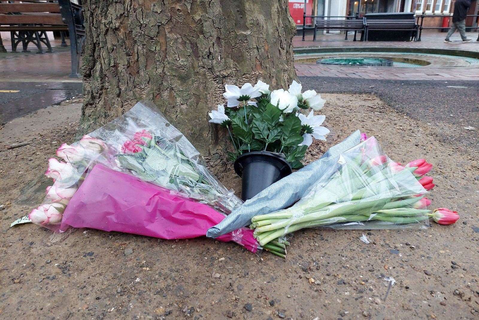 Flowers were left near a tree at the scene of the woman's death