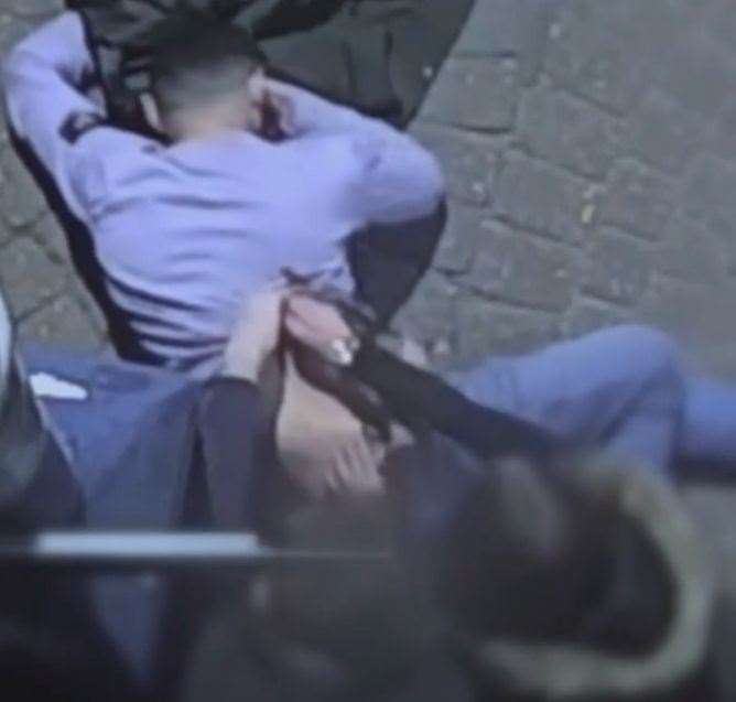 The CCTV captures how two people try to staunch the stab wound in Kurtis White's back