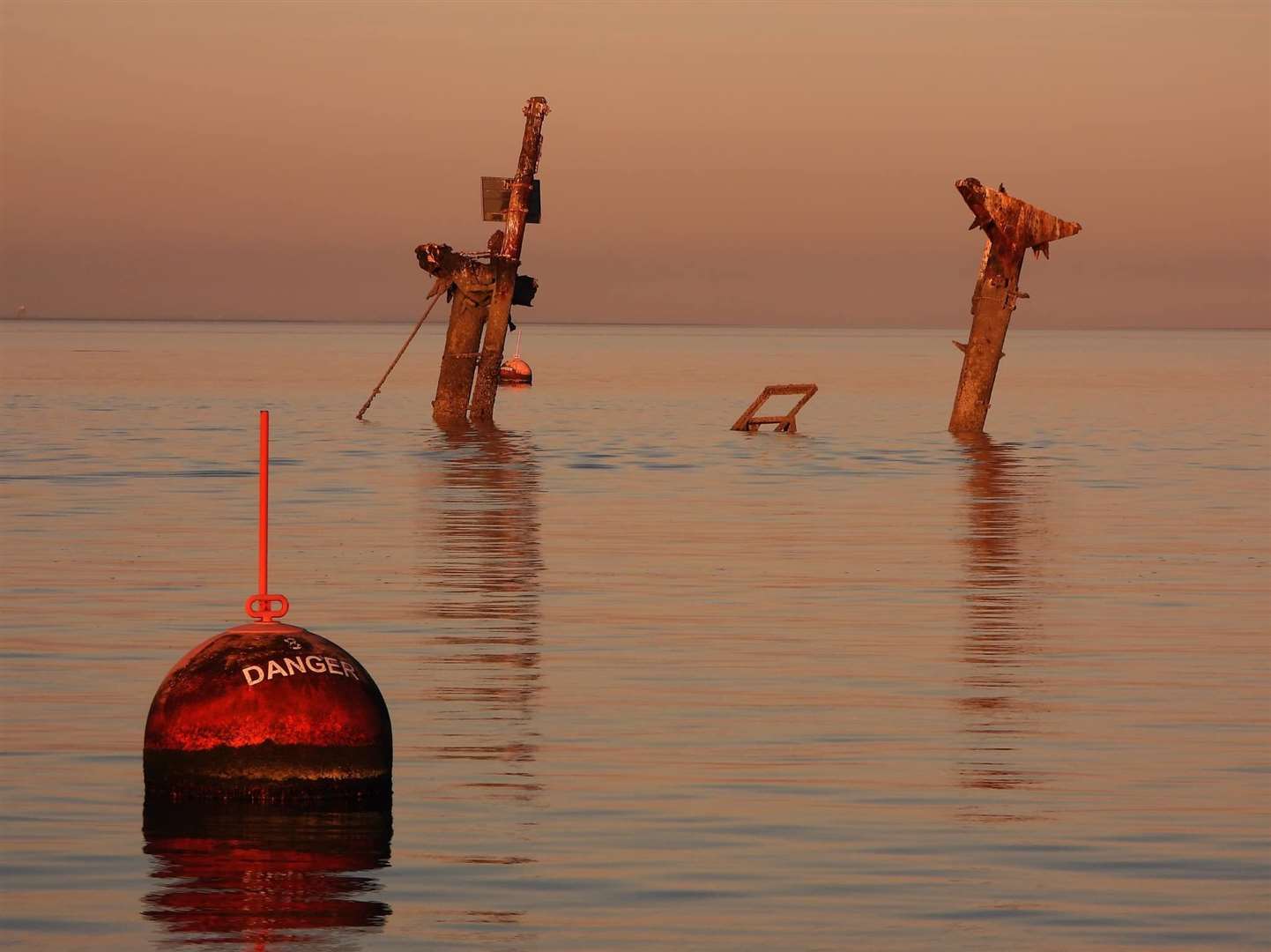 Danger buoy and distinctive masts of the American bomb ship SS Richard Montgomery wreck off Sheerness. Picture: Margaret Flo McEwan