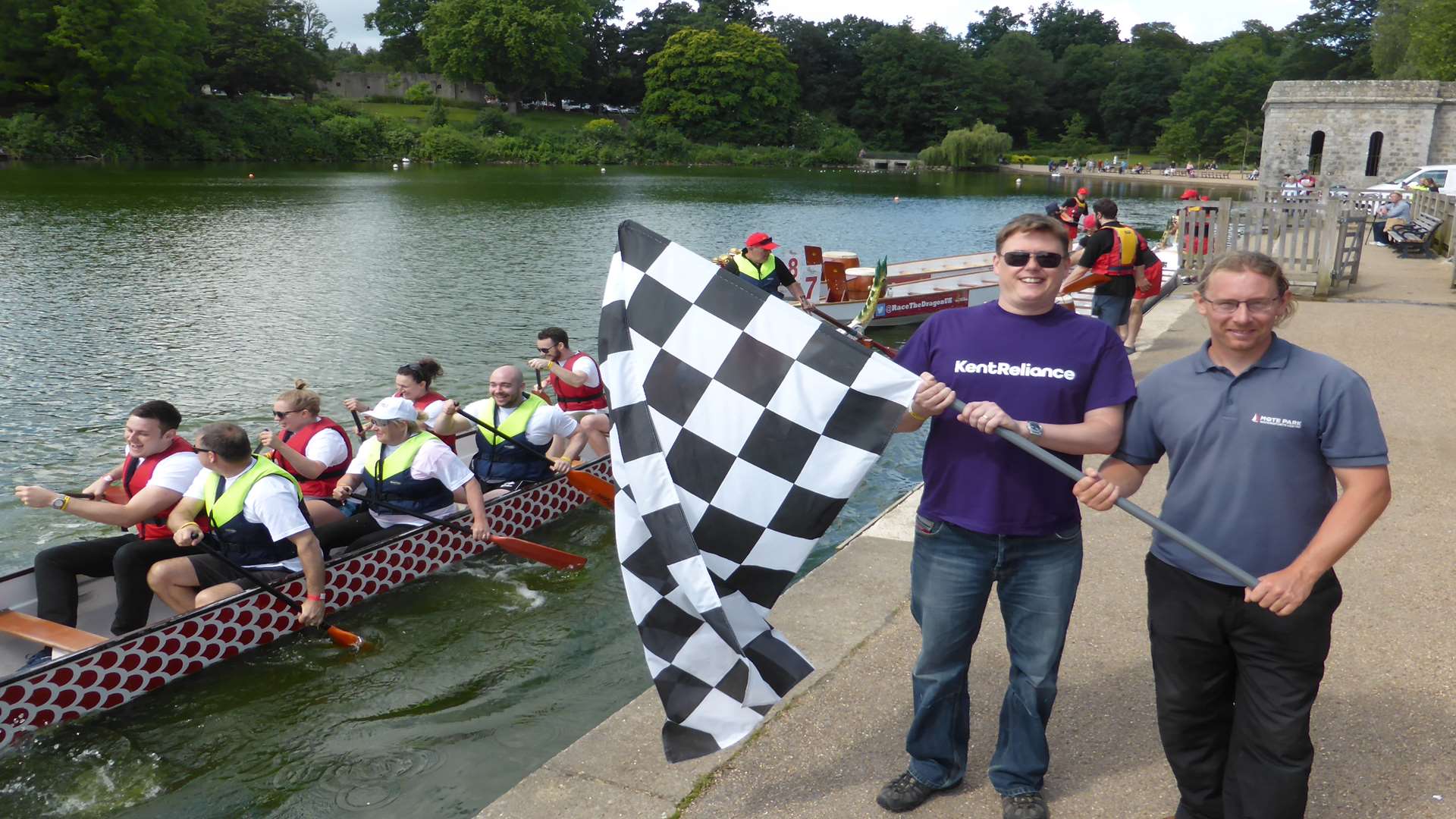 Robert Gurr of Kent Reliance and Stuart Clarke of Mote Park Water Sports Centre waves the chequered flag and gets the record-breaking 2016 KM Dragon Boat Race underway.