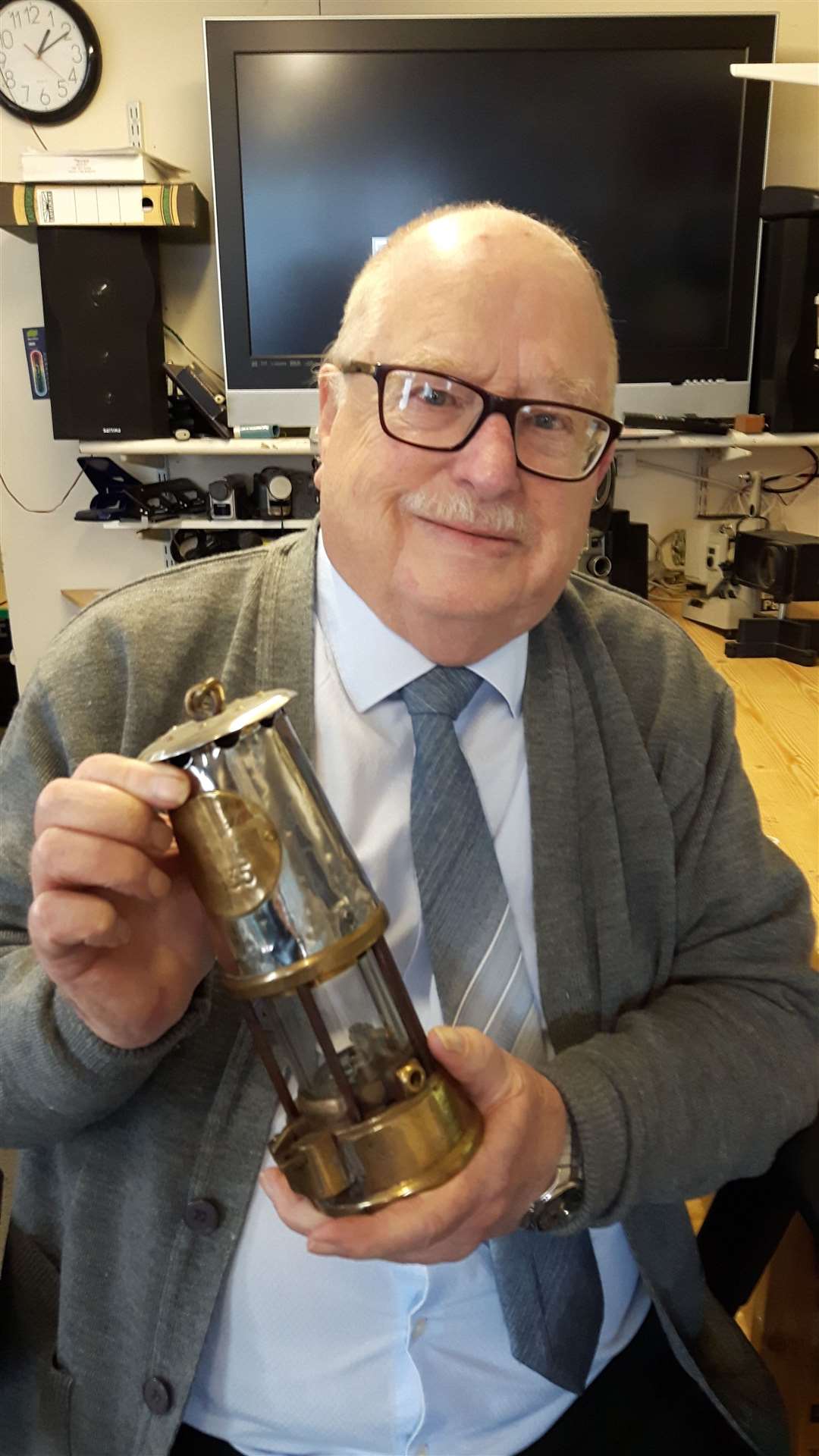Former miner Jim Davies, pictured with his old Davey lamp and pit check.