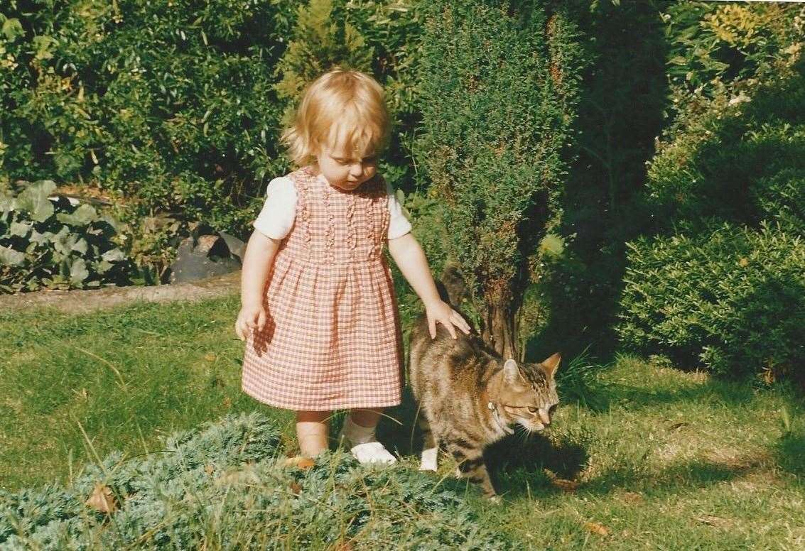 Pip pictured in 1997 with Tigger, one of four cats her parents had when she was born. Picture: Pip Harris