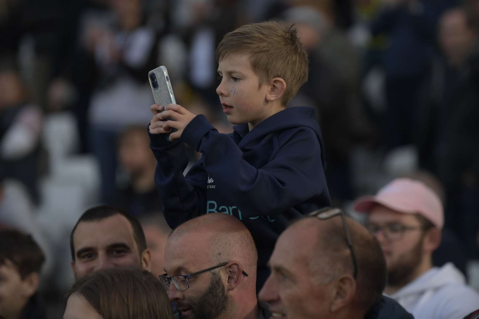 A young fan films the celebrations. Picture: Barry Goodwin