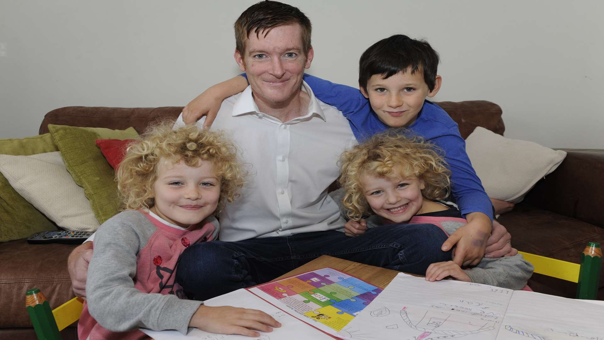 Paul Cartwright with his twin daughters Maya and Ruby, aged six, and partner's son Alex, aged eight