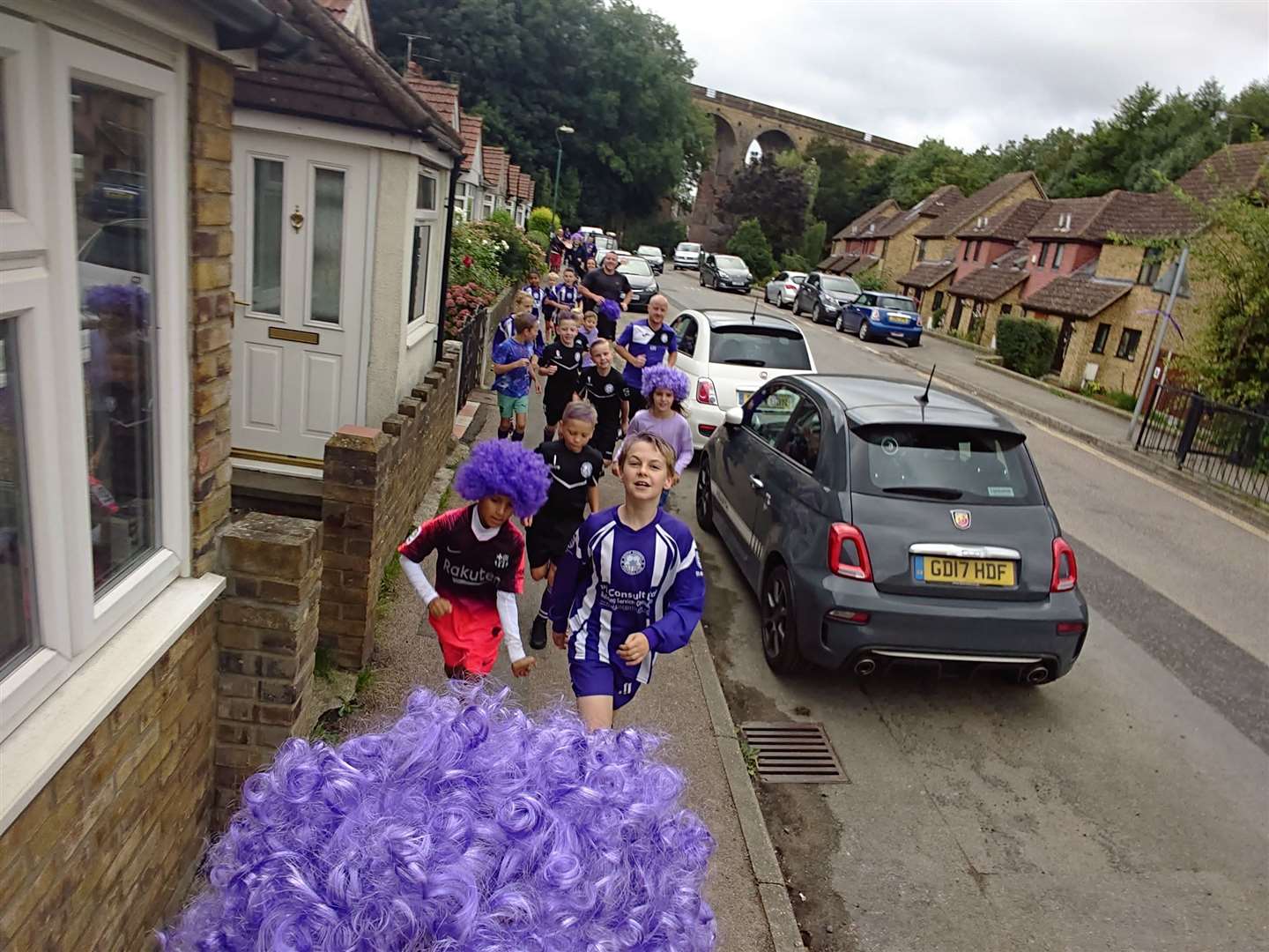 The boys from South Darent Junior football club run through the village with their coaches (16377259).