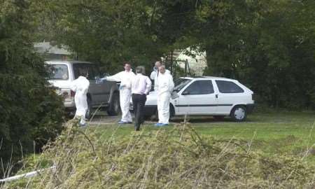 Police officers at the scene of the killing. Picture: DAVE DOWNEY