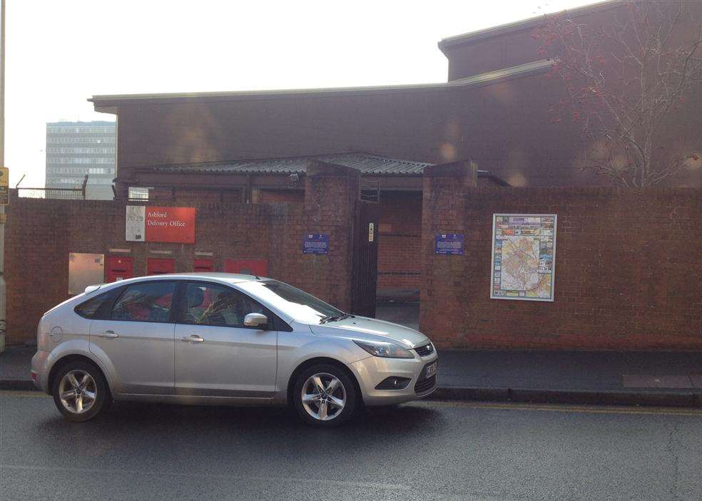 A car parked on double yellow lines outside the Ashford postal delivery office in Tannery Lane