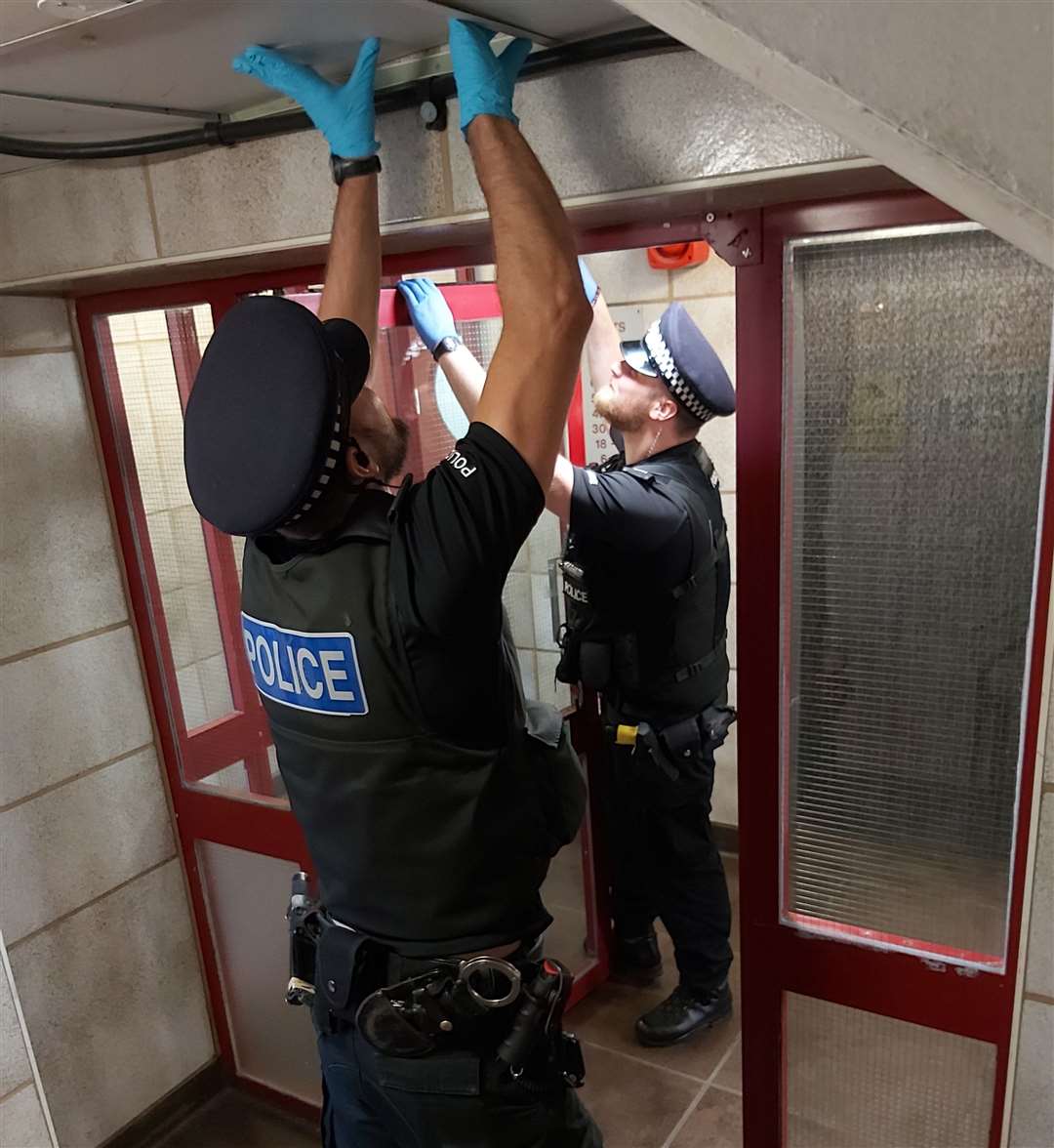 Police at Invicta House, Margate, lift up a ceiling tile. Picture: Kent Police Thanet / Twitter