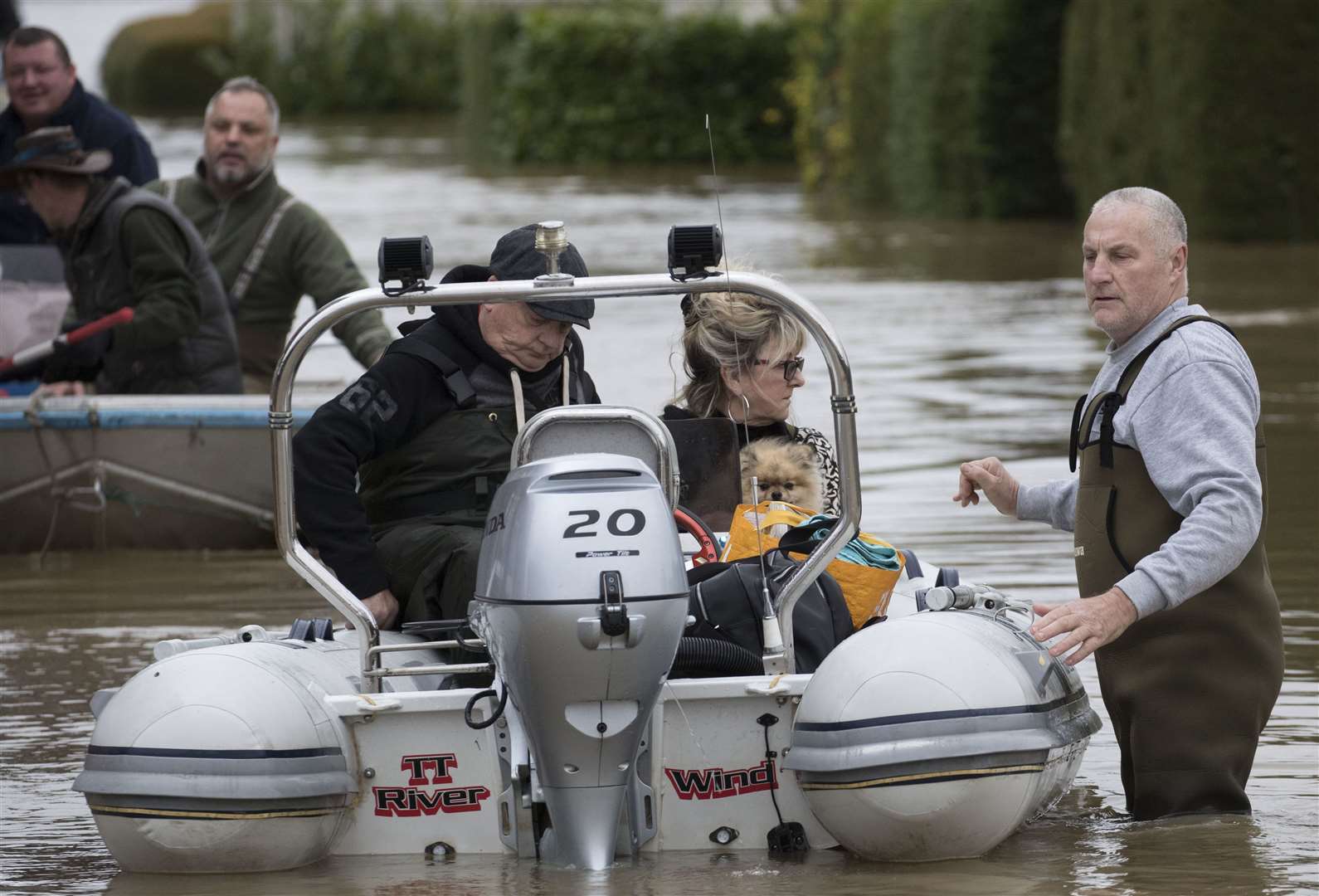 A resident and her dog are ferried by dinghy at the flooded Little Venice Country Park in Yalding. Pic: Stephen Lock/i-Images