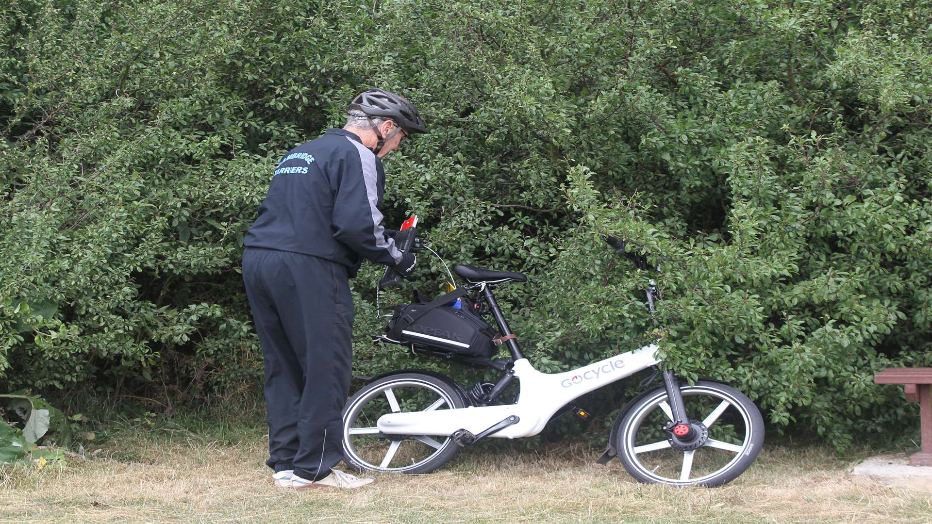 Warwick Dixon travels on his electric bicycle to a local park with his hammer on the back