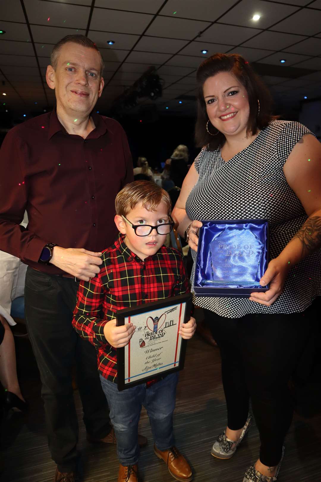 Alfie Mathis, six, pictures with his dad Ben and mum Clare shared the child of the year title with Lexie Braham in the Tesco Pride of the Island awards at Layzells, Minster