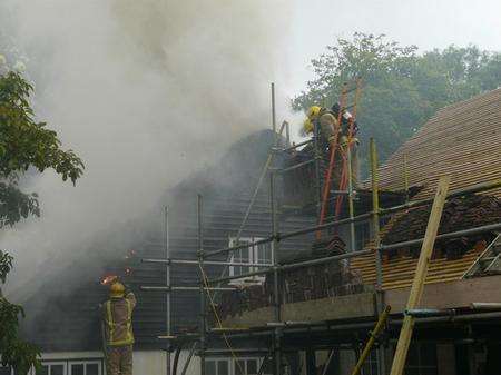 Fire crews tackle a massive blaze in a thatched roof at Wooton, near Canterbury. Picture: KFRS