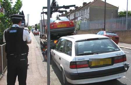 PC Dave Saunders overseeing the seizure of an untaxed car