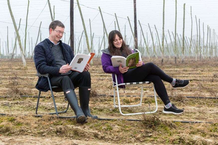 (Left-right) Shepherd Neame's senior brewer Stewart Tricker and technical brewer Danielle Whelan read to the hops at Parsonage Farm
