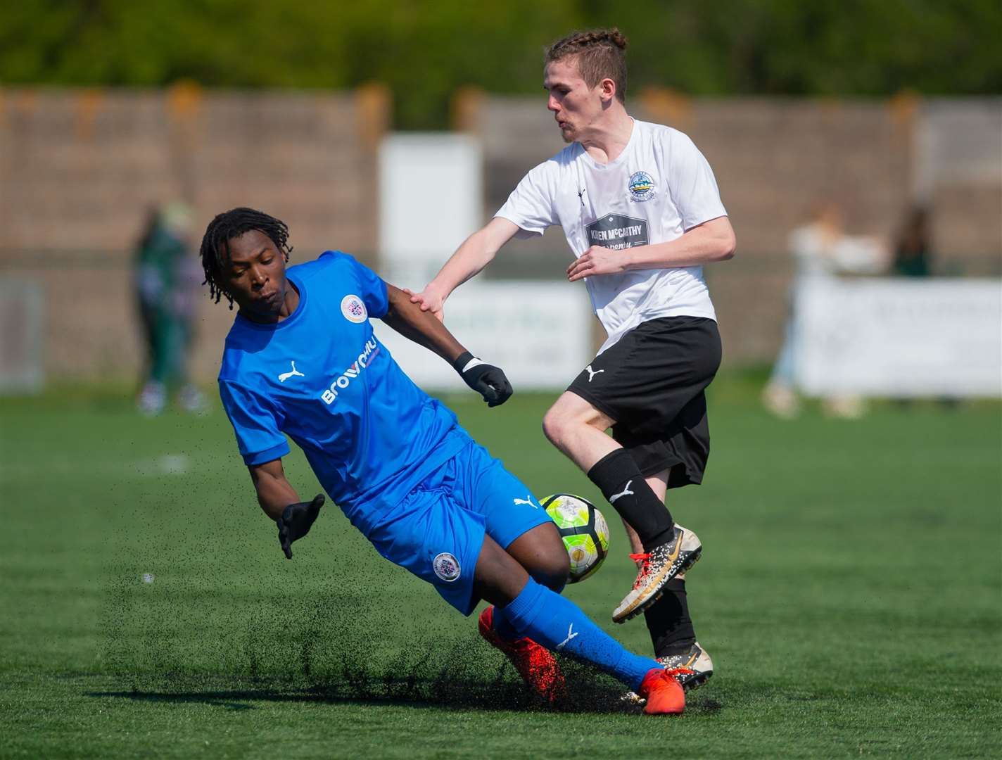 Bromley under-16s (blue) slide in against Dover Athletic under-16s. Picture: PSP Images