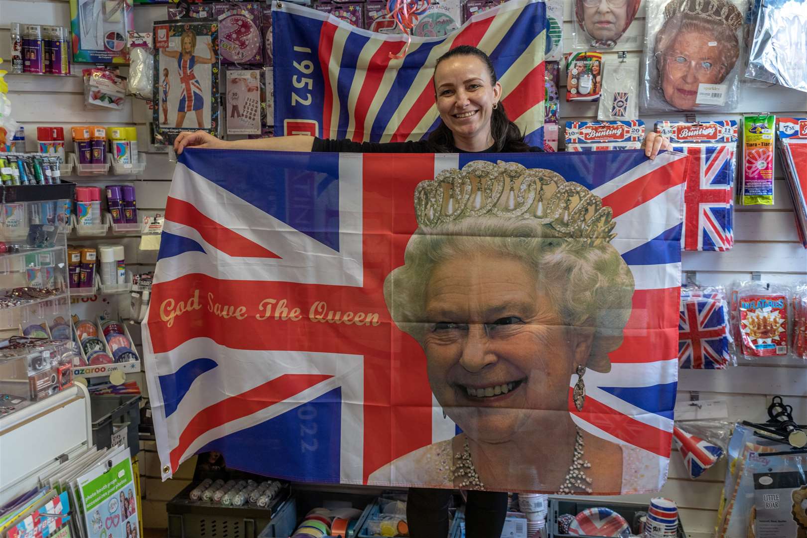 Shopkeeper Erika Drumstaite stands holding a union flag in Party Bitz fancy dress shop in Sheerness. Picture: SWNS/Gwyn Wright