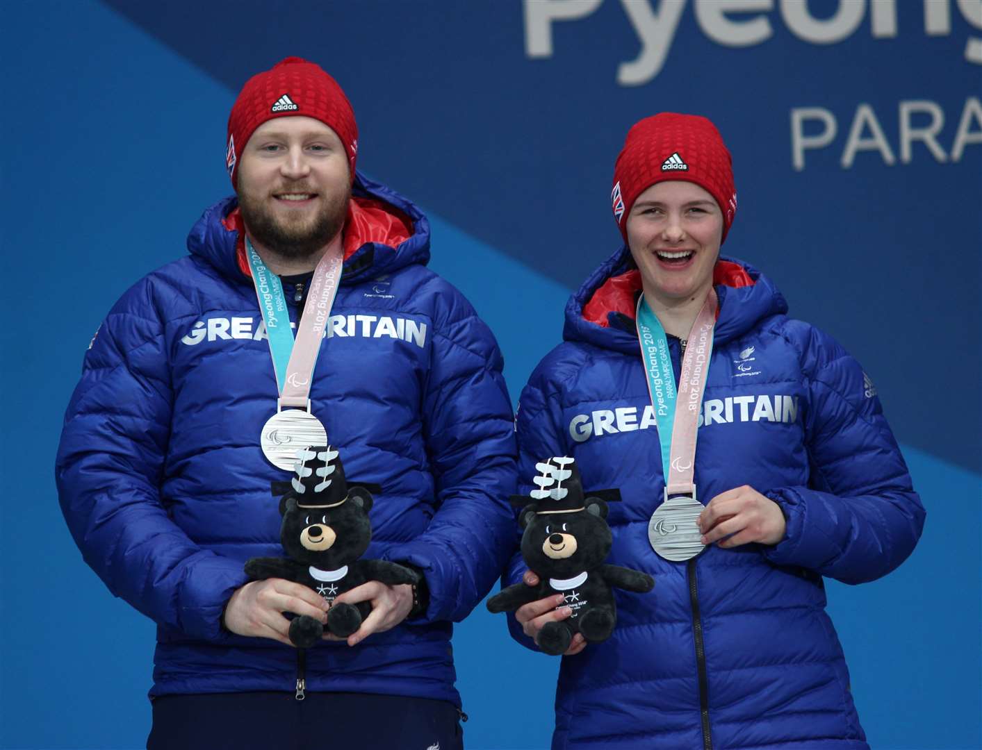 Knight and her guide Wild celebrate winning silver at the Winter Paralympics in South Korea